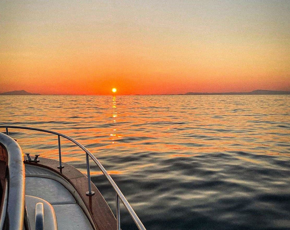 Sunset boat cruise over calm Tyrrhenian Sea near Sorrento