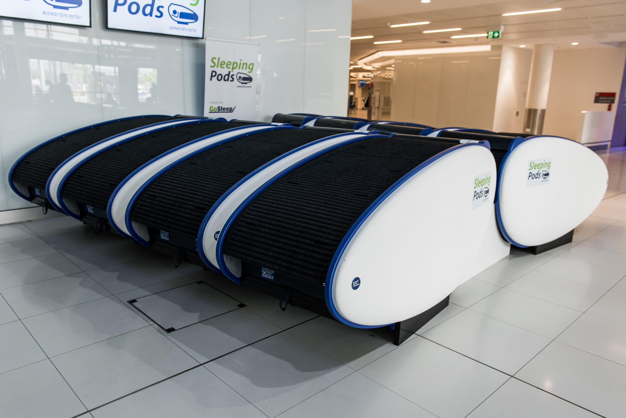 Line of sleep pods in airport terminal for transit rest stops
