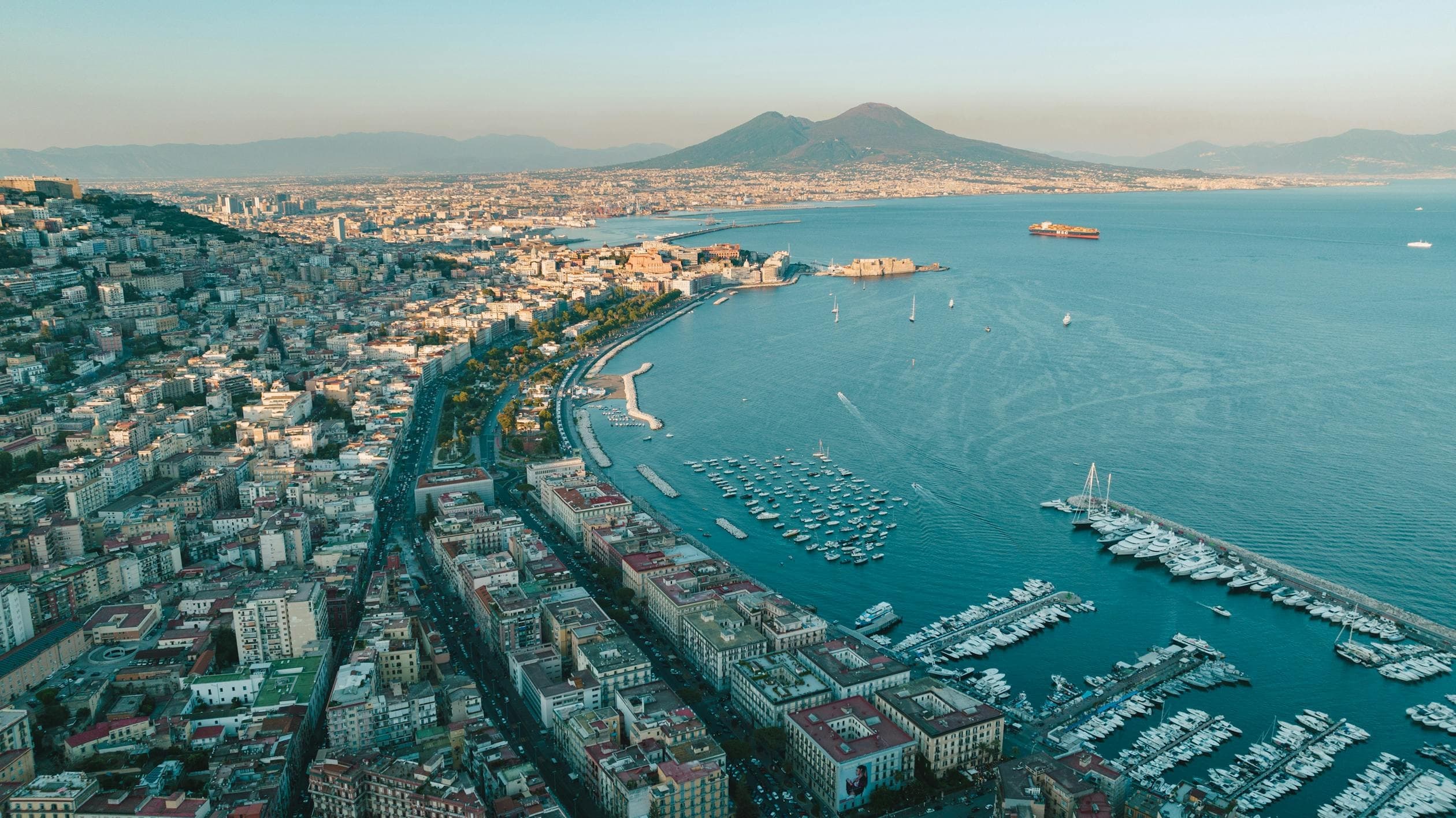 Naples bay aerial view with marina and Mount Vesuvius backdrop