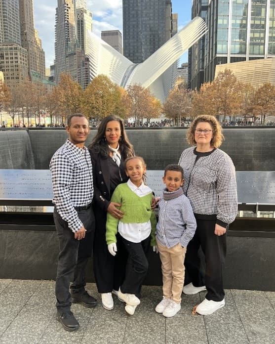 Family at 9/11 Memorial with World Trade Center Oculus backdrop