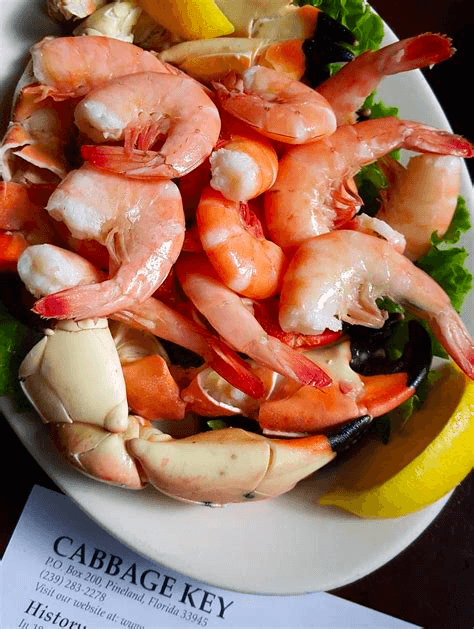 Seafood platter featuring shrimp and crab claws at waterfront eatery