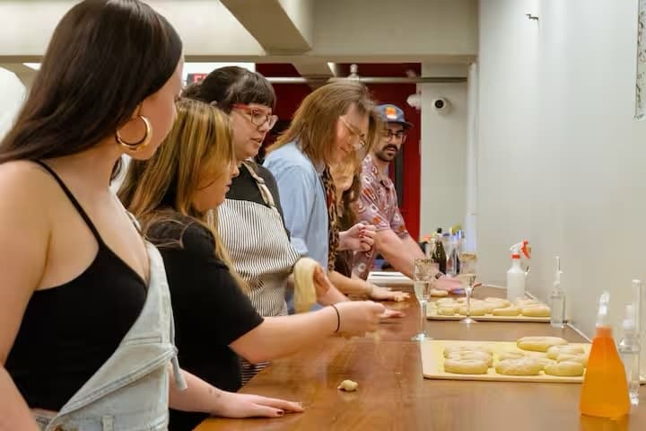 Participants forming bagels at countertop during NYC bagel class