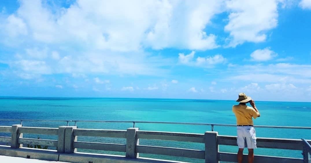 Visitor admiring turquoise ocean from Florida Keys waterfront viewpoint