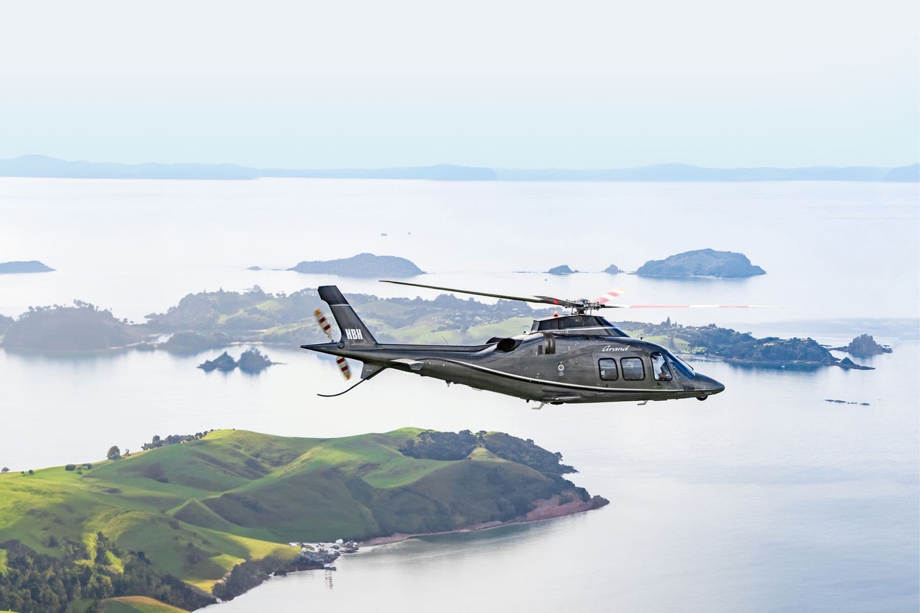 Scenic helicopter flight over island archipelago and coast