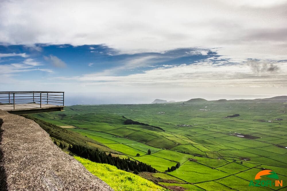 Scenic cliffside viewpoint over green Azores farmland and ocean
