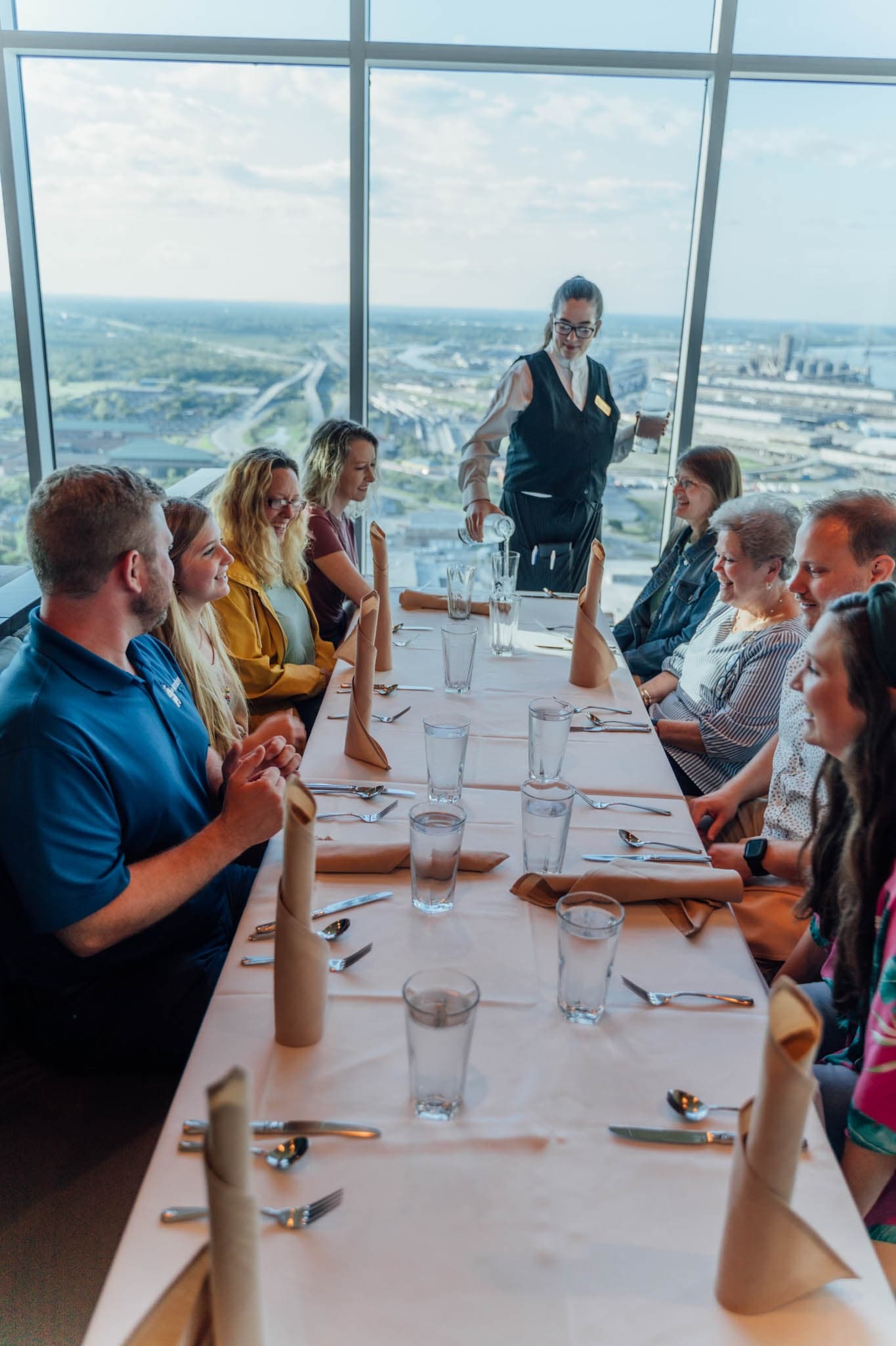 Panoramic waterfront dining with skyline views from high-rise