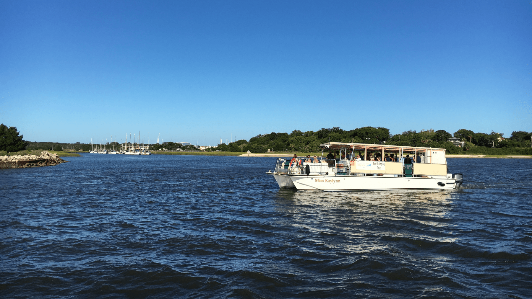 Tour boat cruising Amelia River under clear blue sky