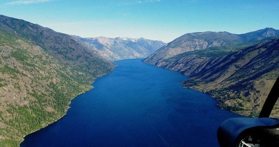 Aerial helicopter tour over scenic Lake Chelan canyon valley