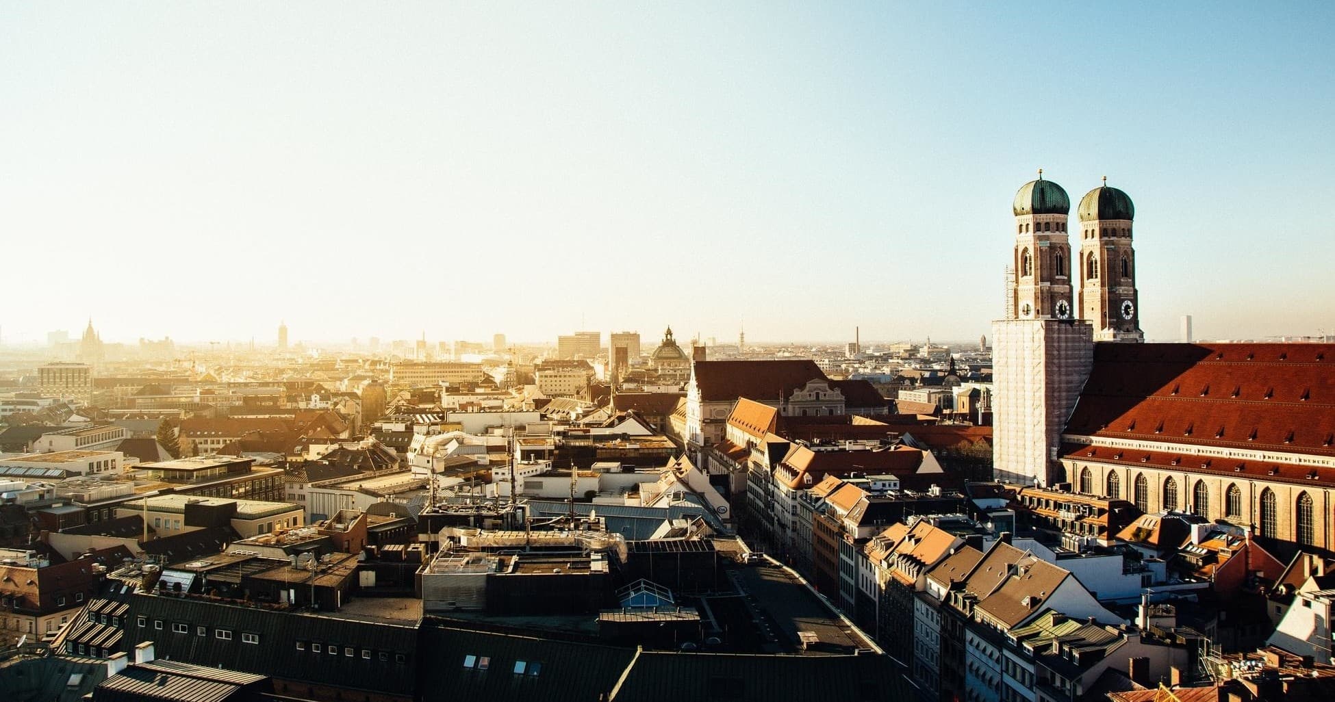 Panoramic city skyline with historic cathedral towers at sunset
