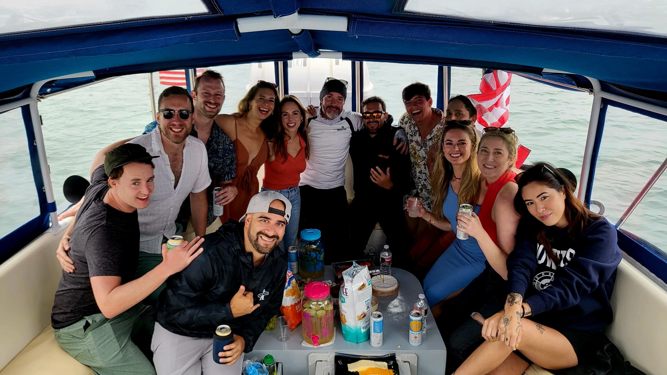 Friends socializing inside boat cabin during coastal boat tour
