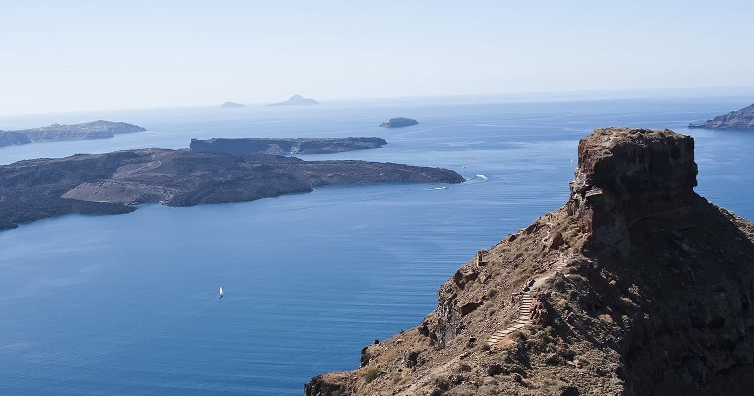 Clifftop caldera overlook with volcanic islets and open sea