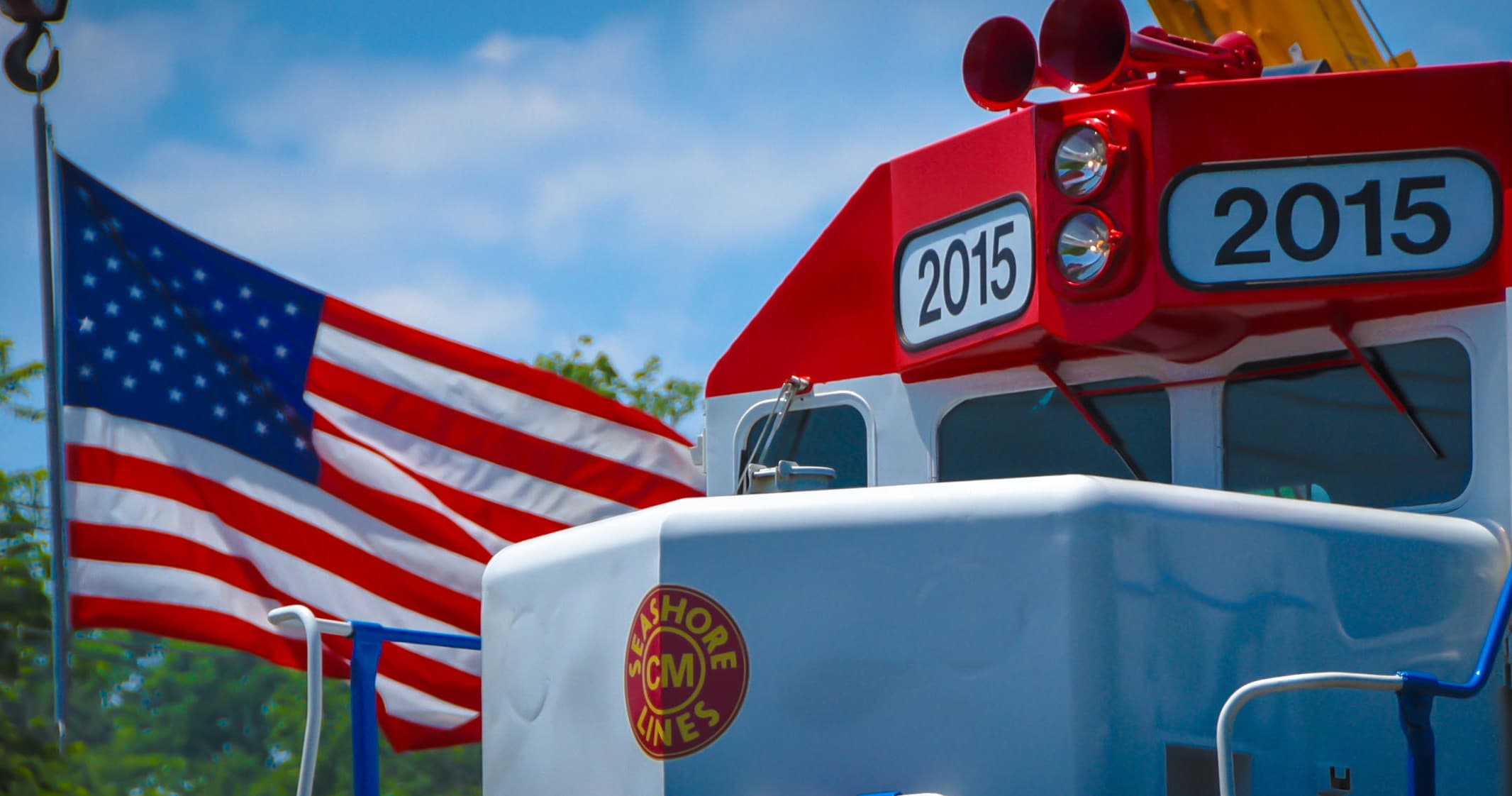Flag-decorated locomotive front at historic seaside rail station
