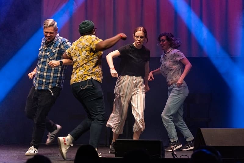 Comedic sketch performers mid-performance on stage