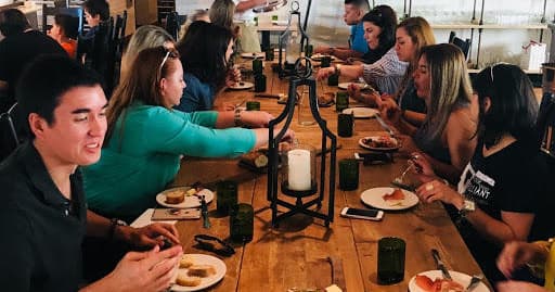 Group dining at long communal table on St. Pete food tour