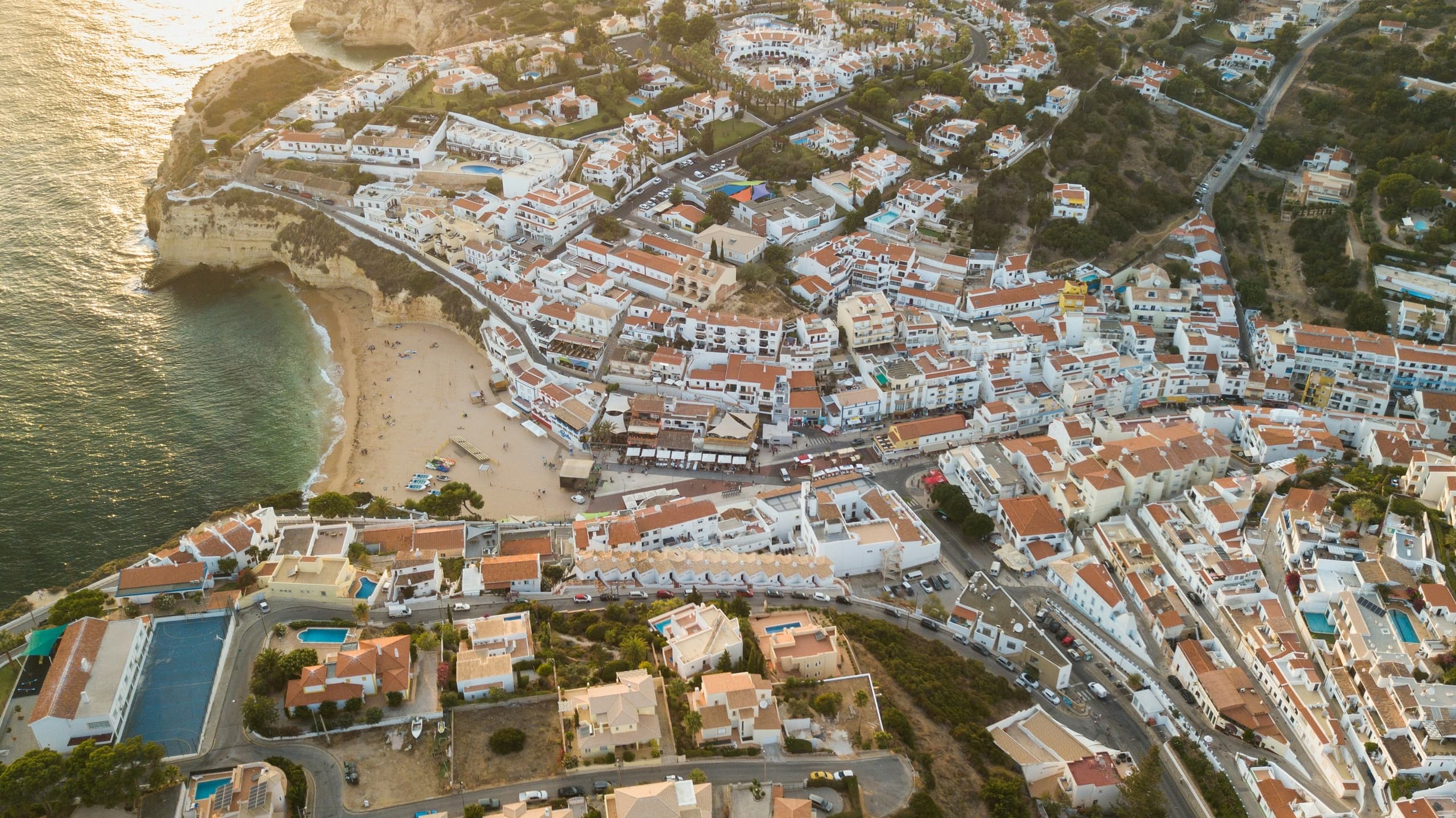 Aerial shot of seaside village and packed bay from above
