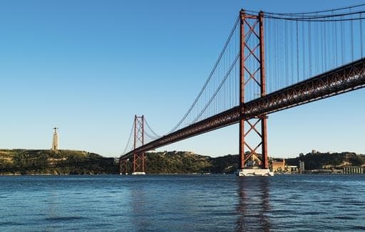 Iconic red suspension bridge over Tagus River near Lisbon