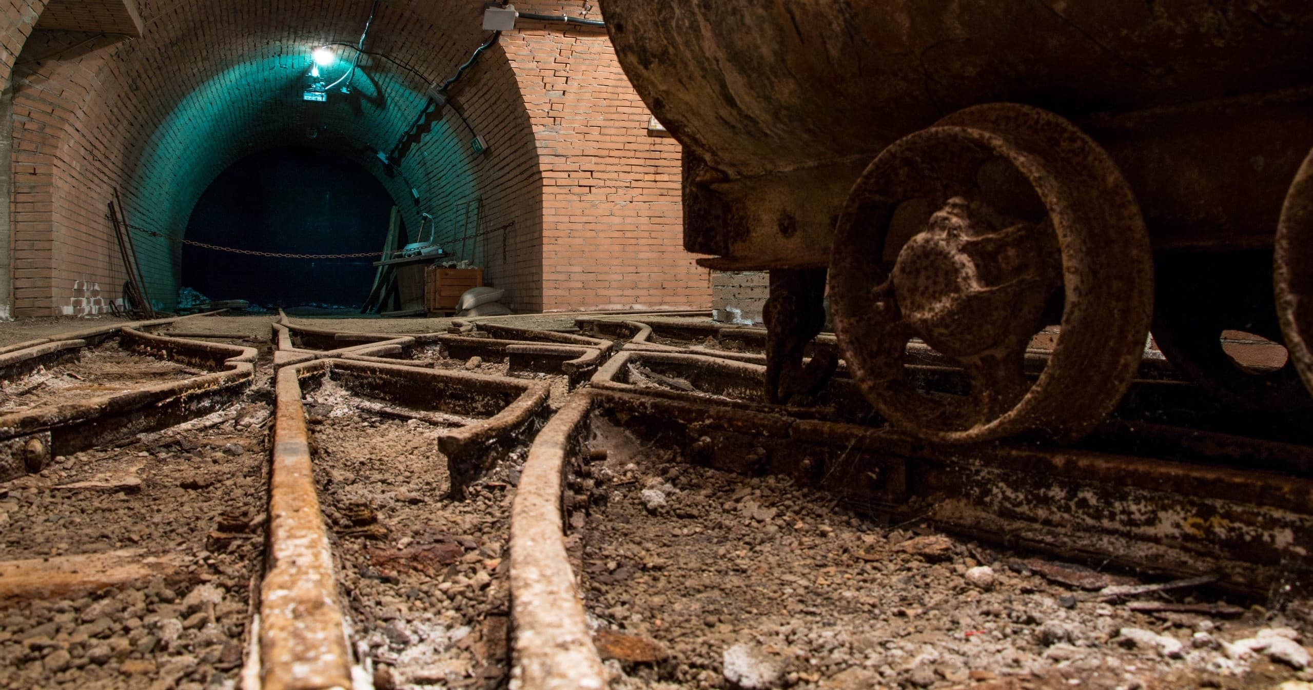 Historic coal mine tunnel with mining cart, underground museum tour