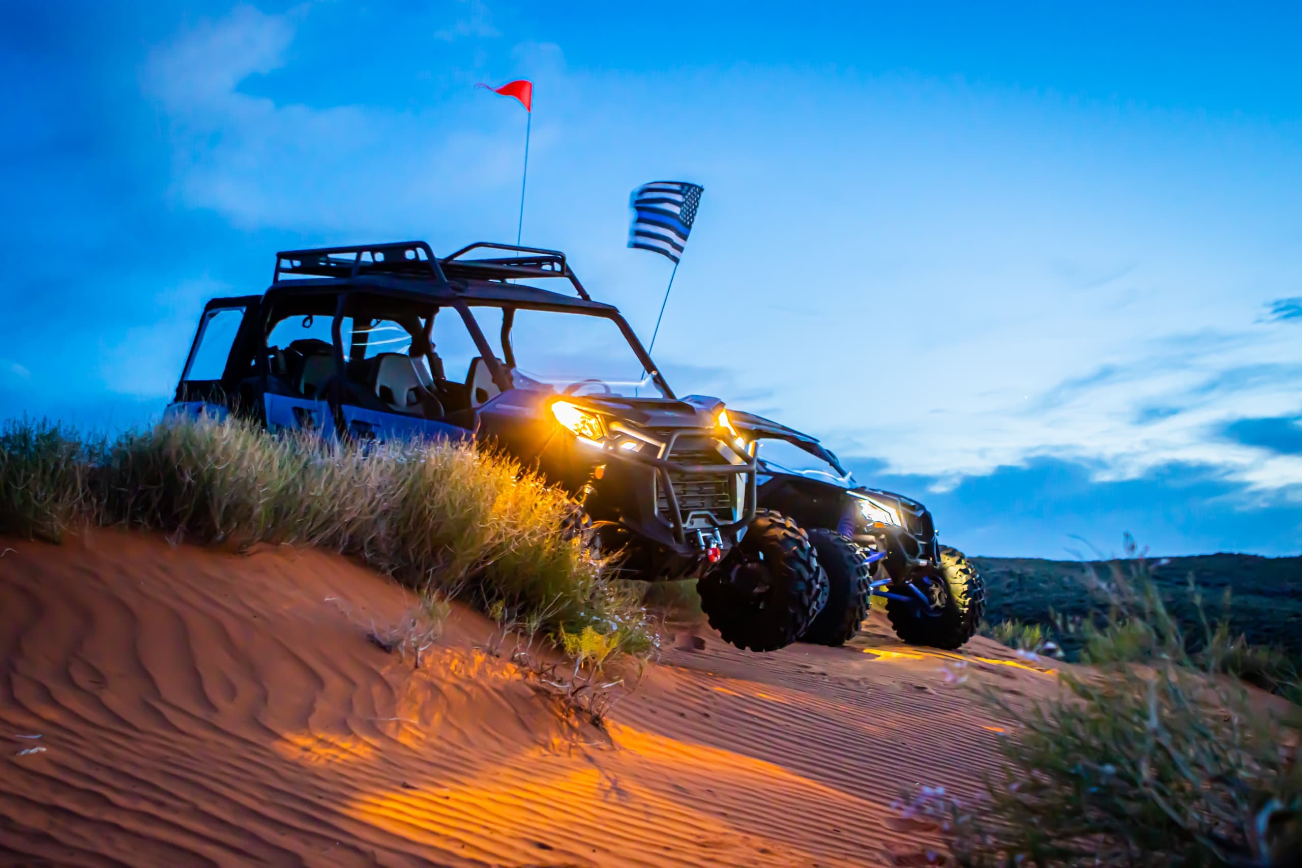 Night dune buggy tour under blue sky, dramatic off-road scene