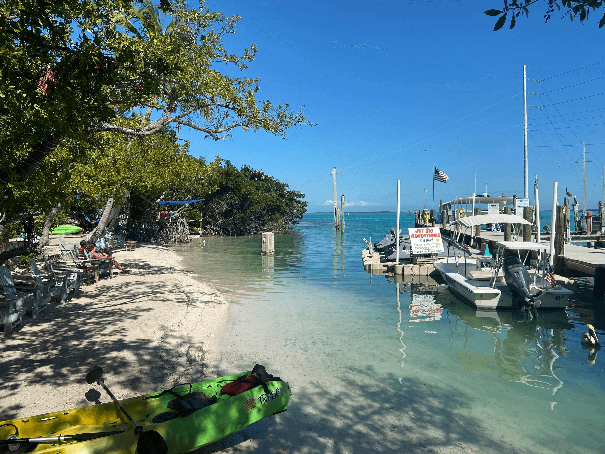 Florida Keys shallow beach with kayaks and docked boats