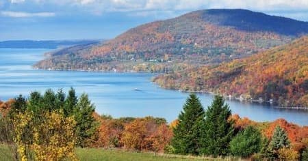 Scenic autumn lake vista with rolling hills and shoreline