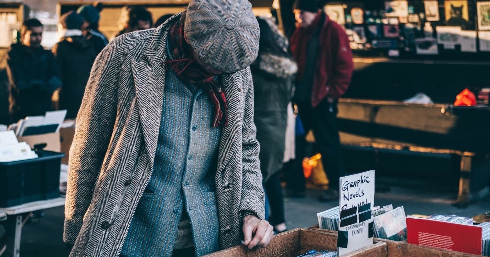 Outdoor street market shopper browsing records and books in London