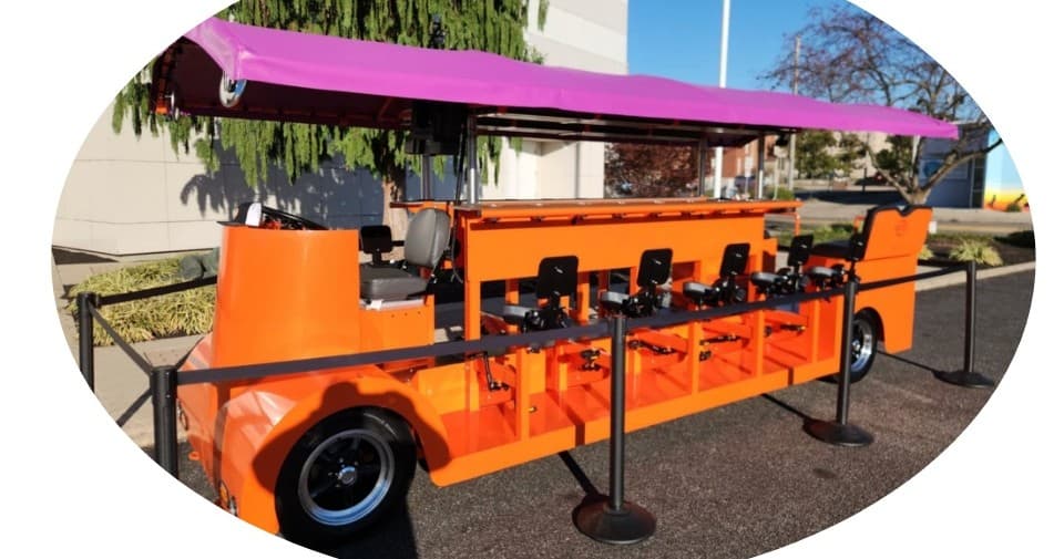 Pedal pub party bike on city street offering group bar crawl tour