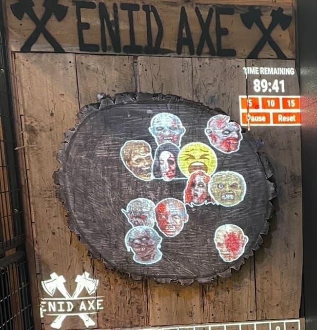 Close-up of axe target with scored stickers at indoor venue
