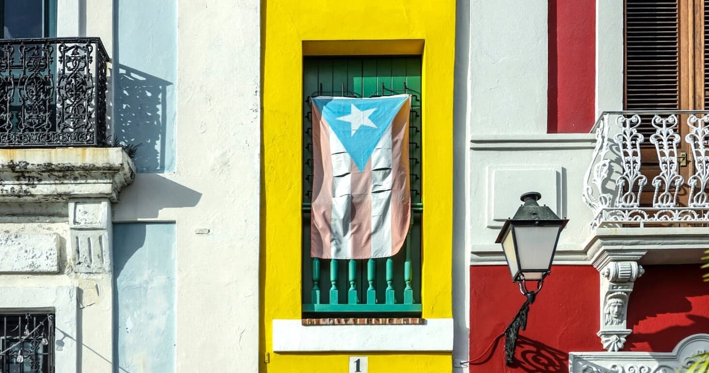 Colorful Puerto Rican building facade with flag in Old San Juan