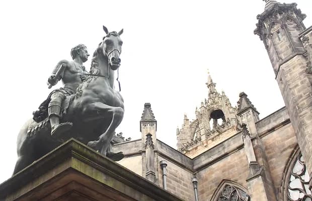 Equestrian statue and cathedral facade on historic city square