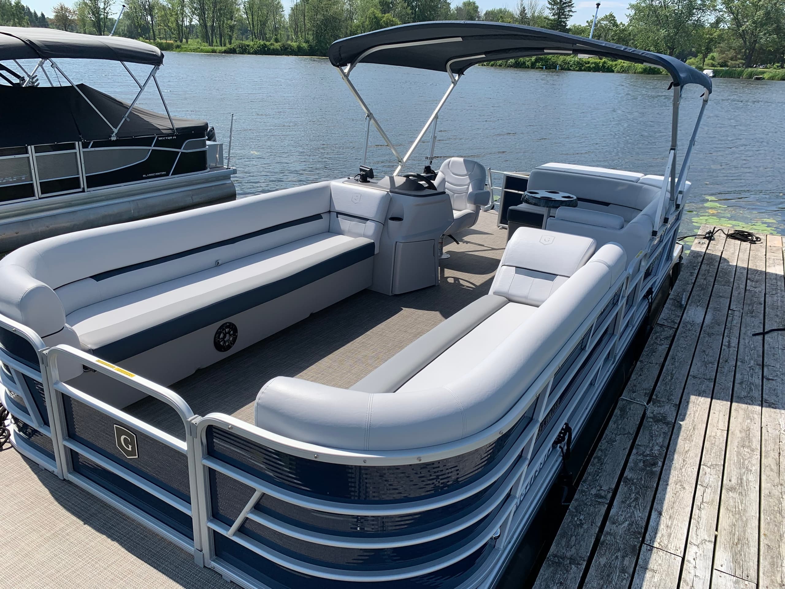 Pontoon boat docked at lakeside marina for relaxed cruising