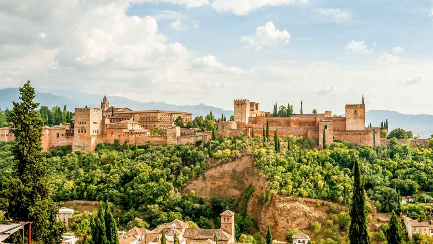 Panoramic Alhambra fortress view over green valley, Spain