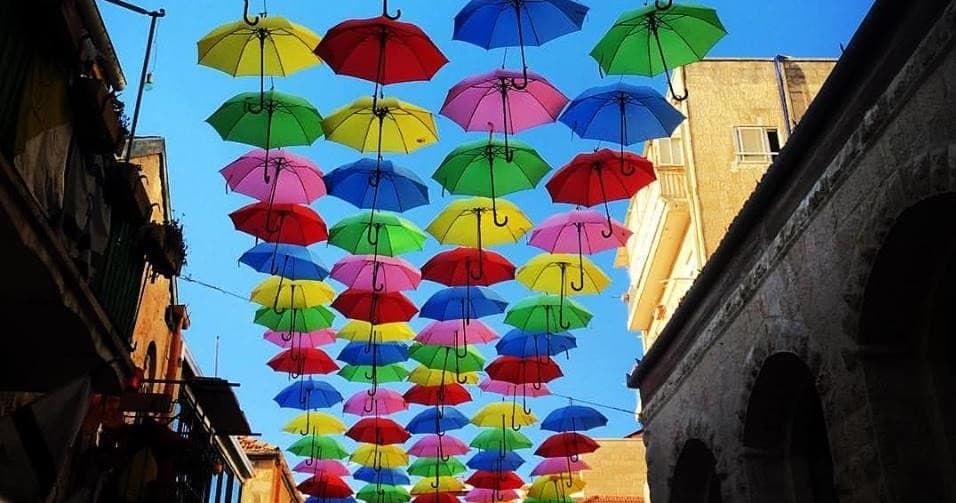 Colorful umbrella canopy art installation over pedestrian street
