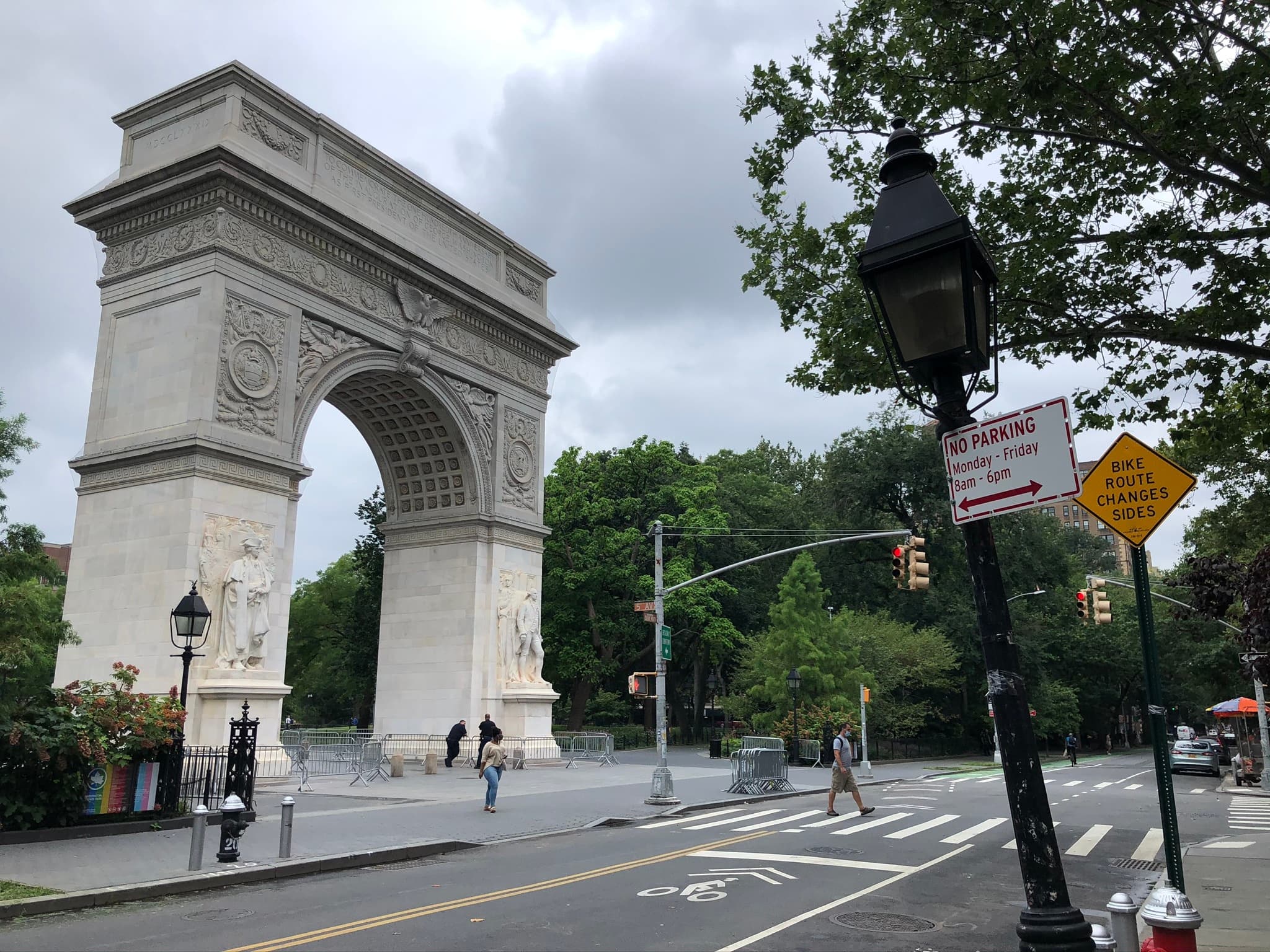 Washington Square Arch framing park entrance and street life