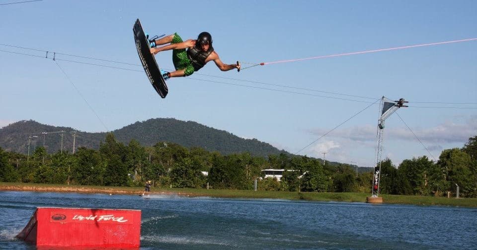Wakeboarder big jump trick over water at Cairns wake park