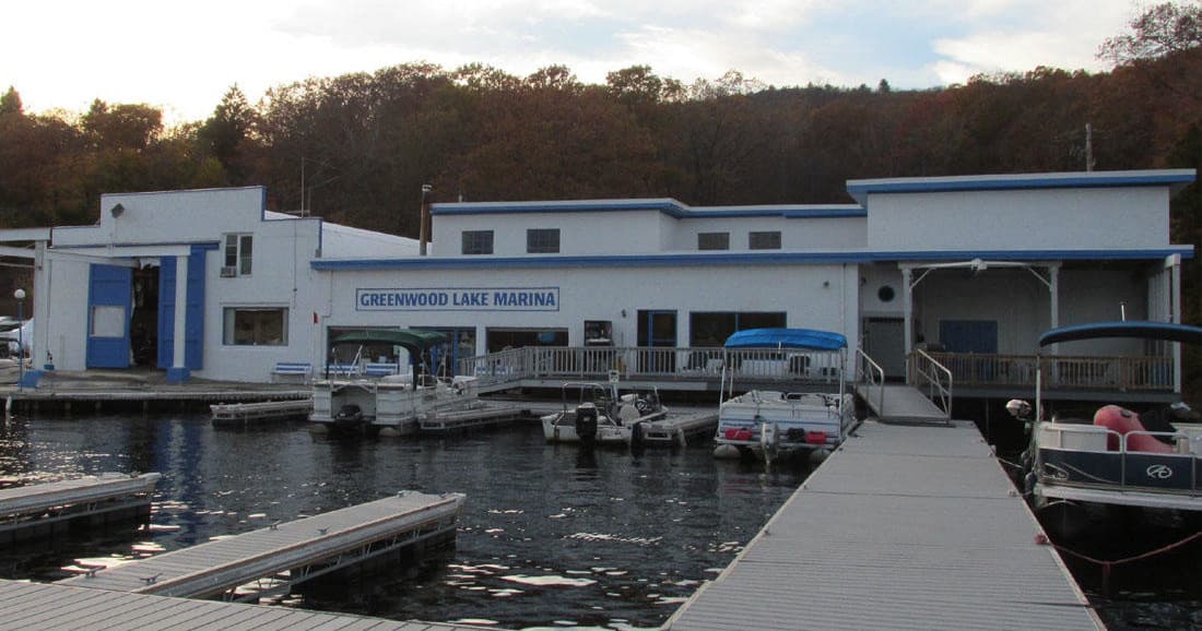 Marina dock and waterfront boathouse at Greenwood Lake marina