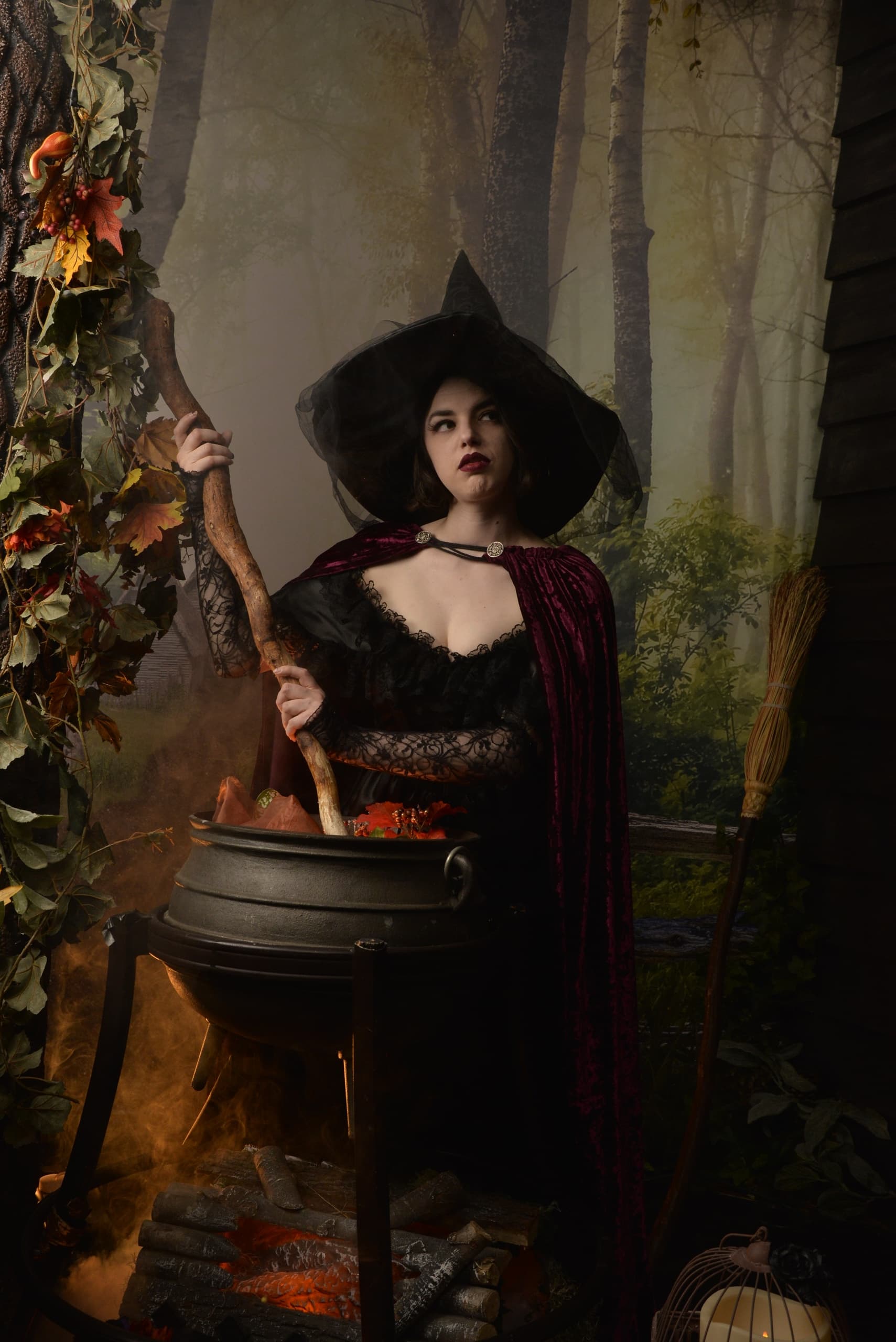 Woman witch stirring cauldron in atmospheric woodland scene