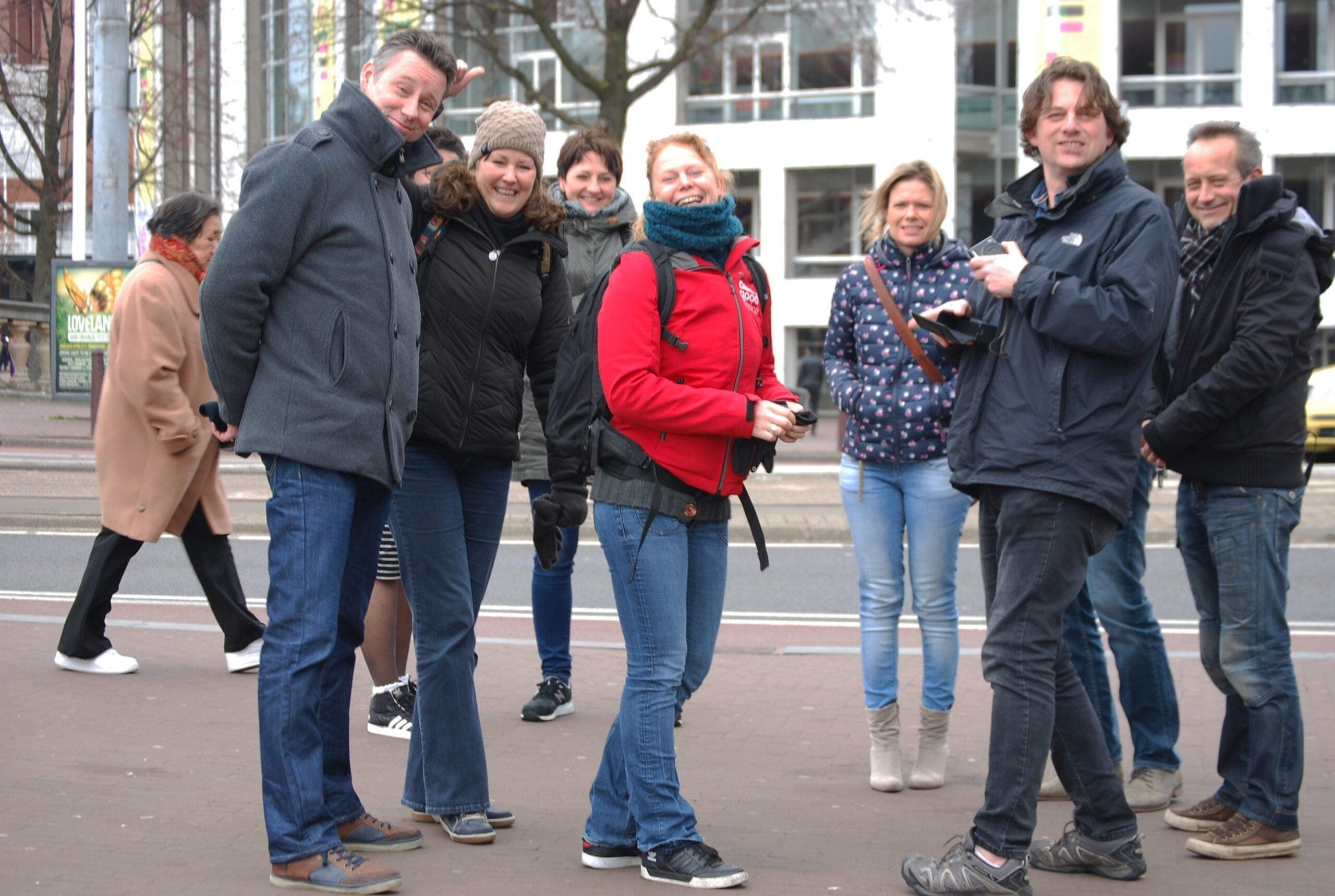 Small walking tour group on urban city street sightseeing