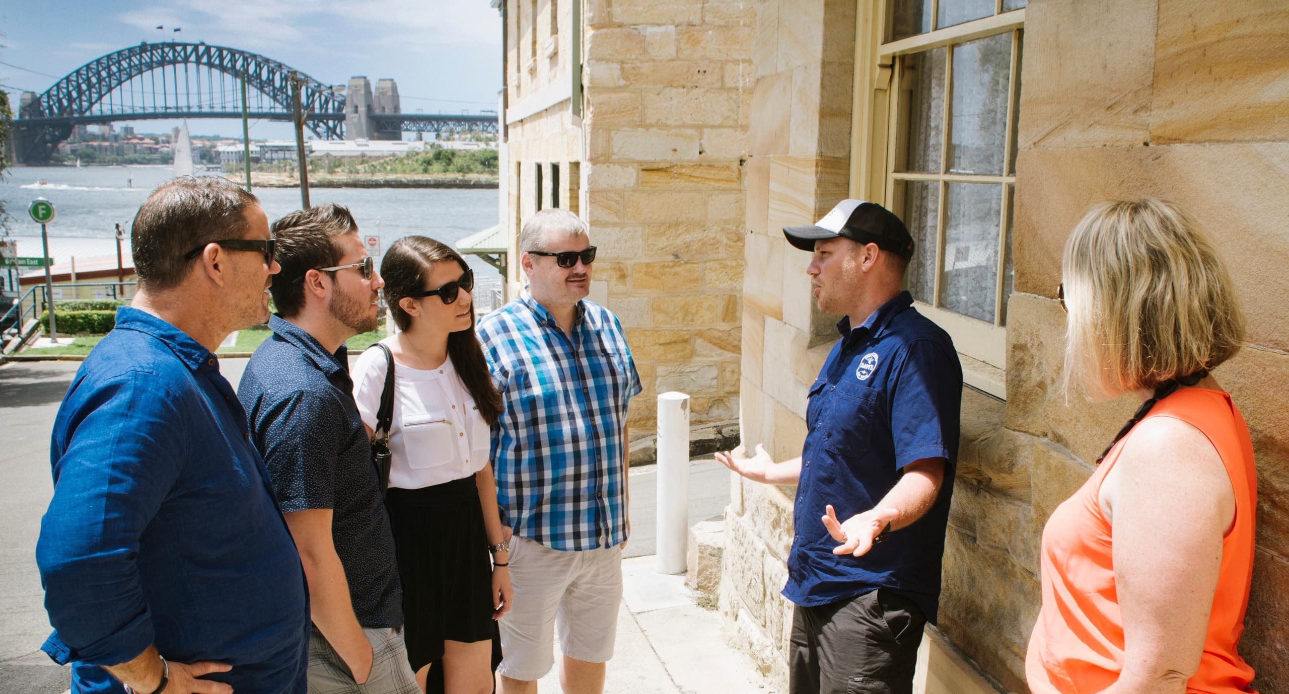 Tour group with guide by Sydney harbourfront and historic site