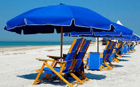 Blue beach umbrellas and chairs lined on sandy shore at Myrtle Beach