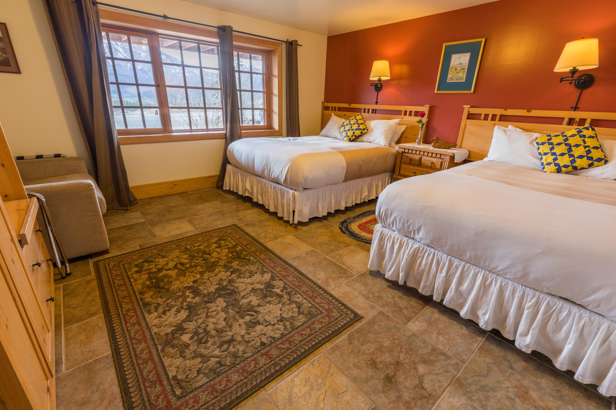 Bright double bedroom in lodge with large window and mountain view