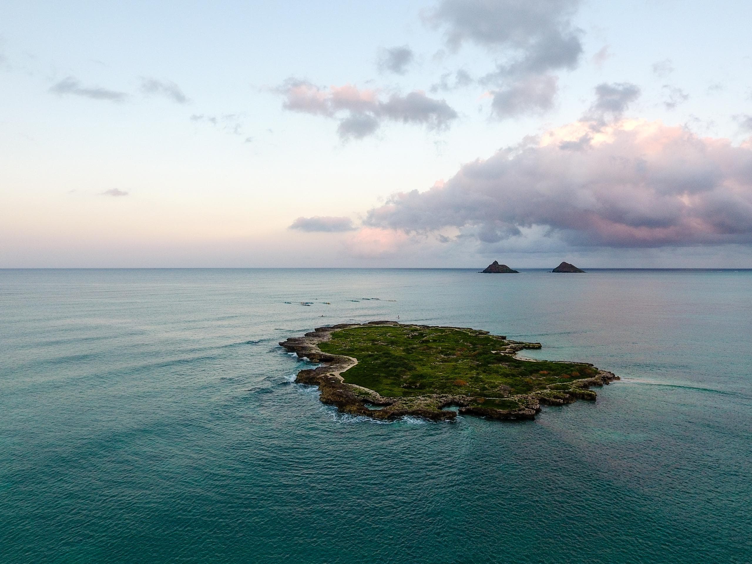 Aerial view of small tropical island and ocean at sunrise
