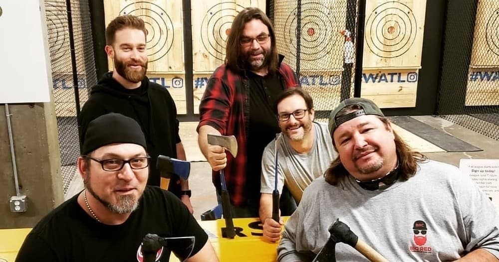 Group axe throwing session at indoor lane with targets