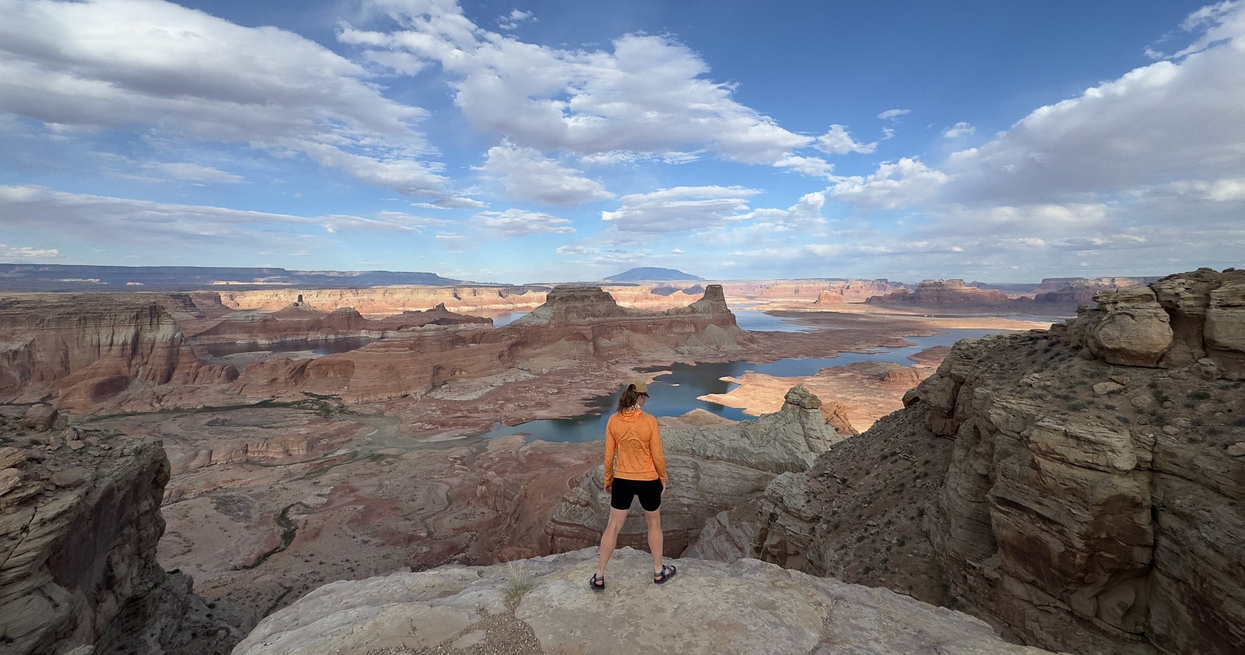 Wide red-rock canyon vista framed by dramatic cliffs at dusk