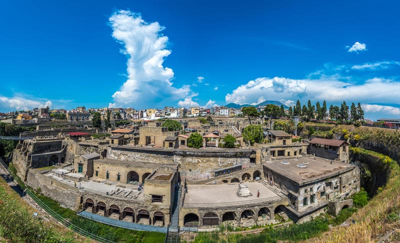 Aerial view of ancient Roman amphitheater ruins near coast