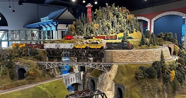 Detailed model train layout with mountain scenery in museum diorama