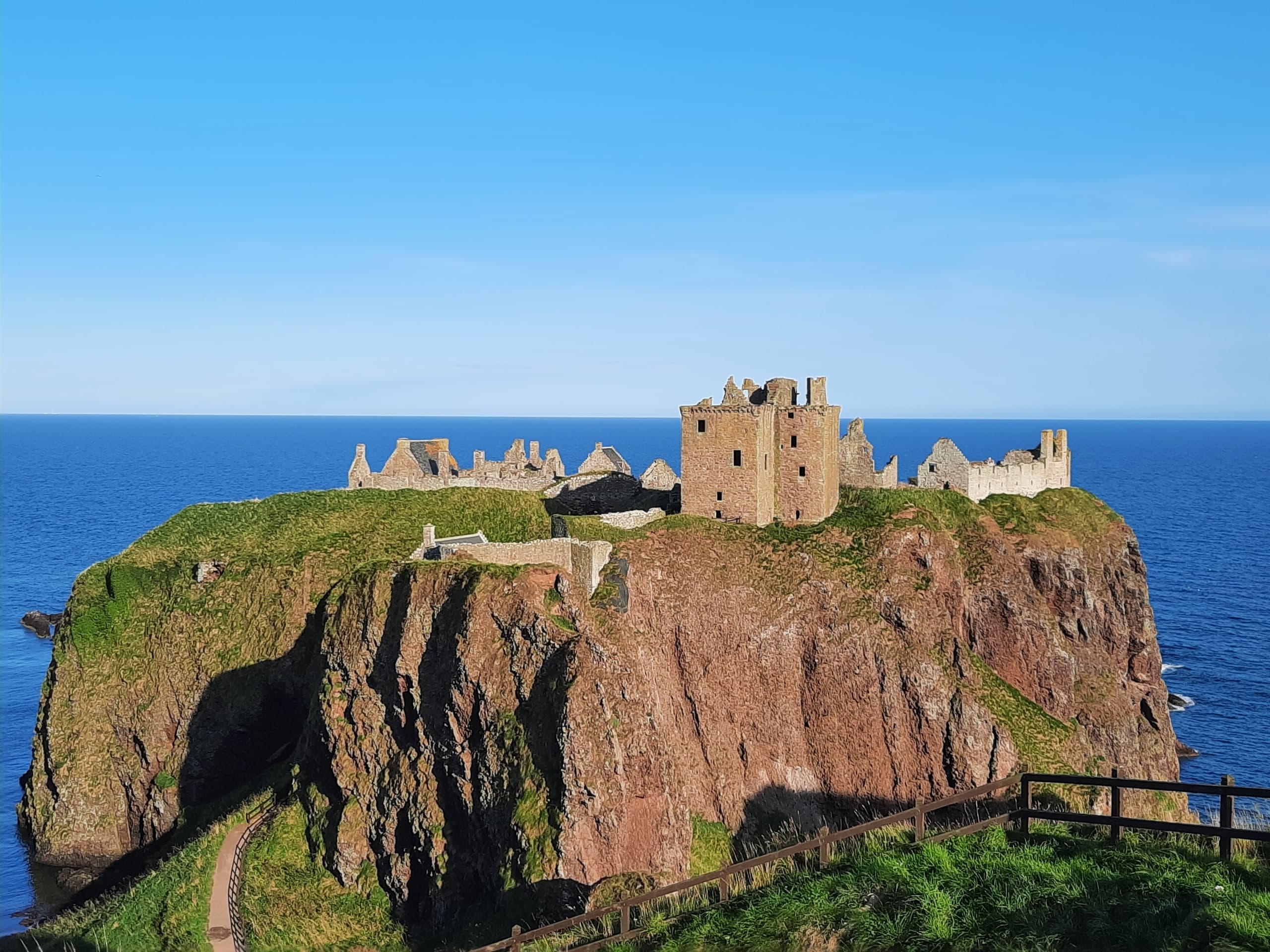 Dunnottar Castle perched on sea cliff, dramatic coastal ruins