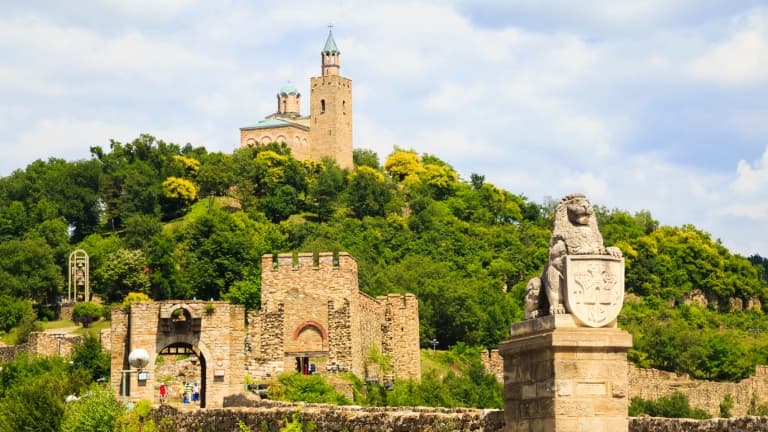 Hilltop medieval fortress overlooking green landscape, exploring