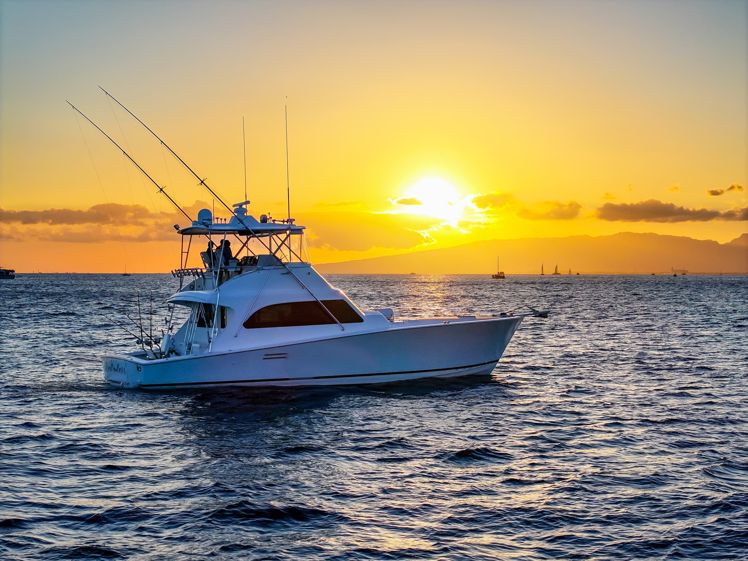 Sportfishing charter boat at golden sunset on open ocean