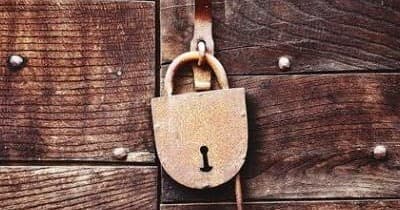 Rusty padlock on wooden door, escape puzzle prop image