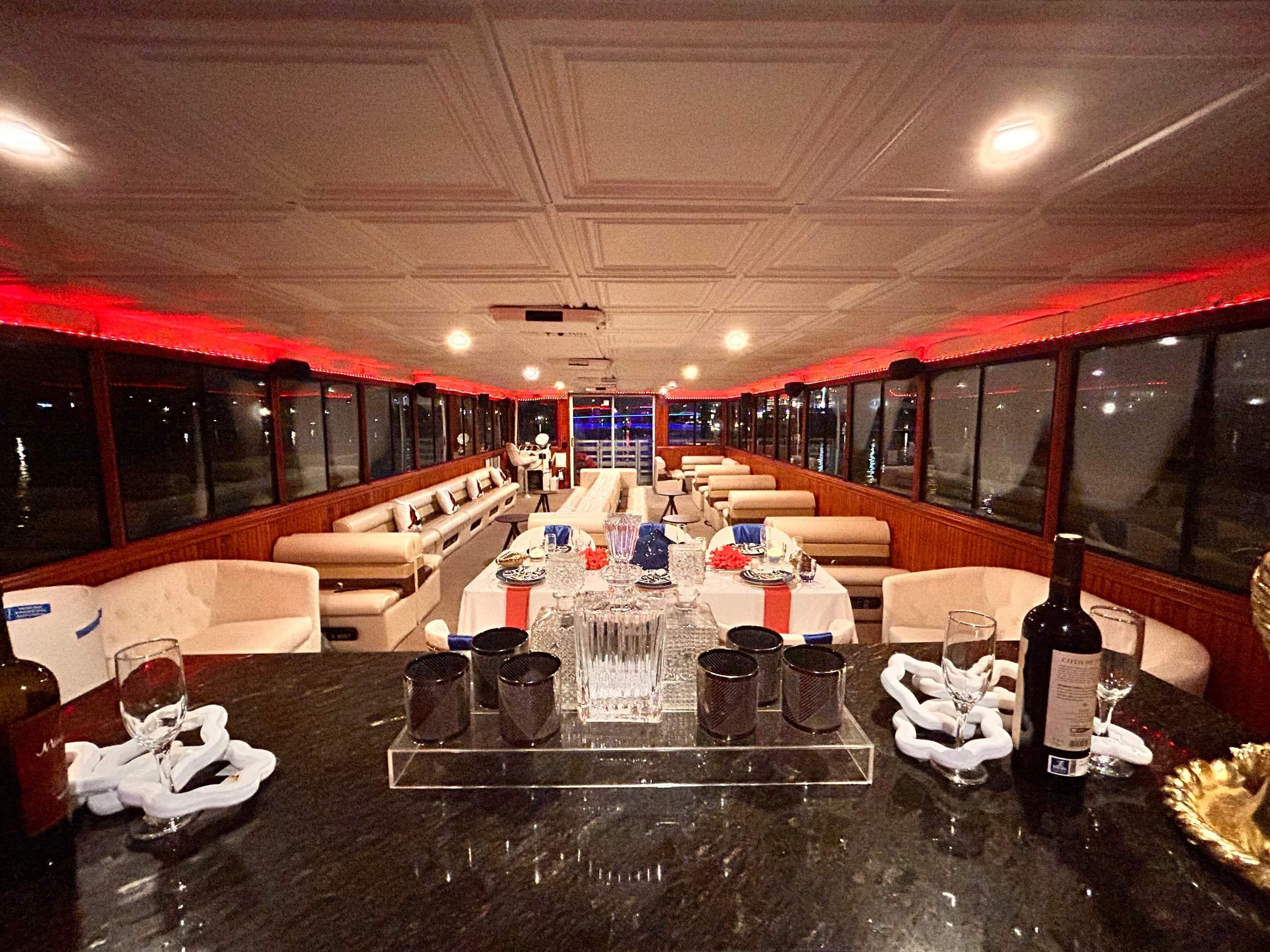 Luxurious indoor yacht dining setup with bar and seating